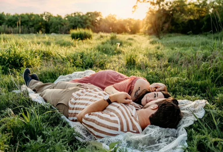 Couple sitting together and laughing, reconnecting through conversation.