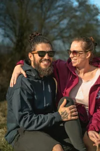 Couple sitting together and laughing, reconnecting through conversation.